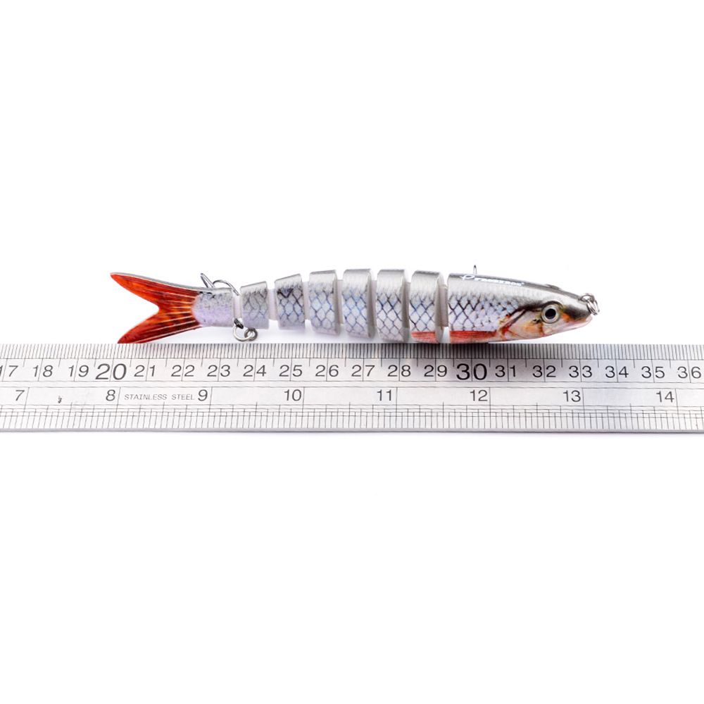 A multi-segment jointed lure next to a ruler